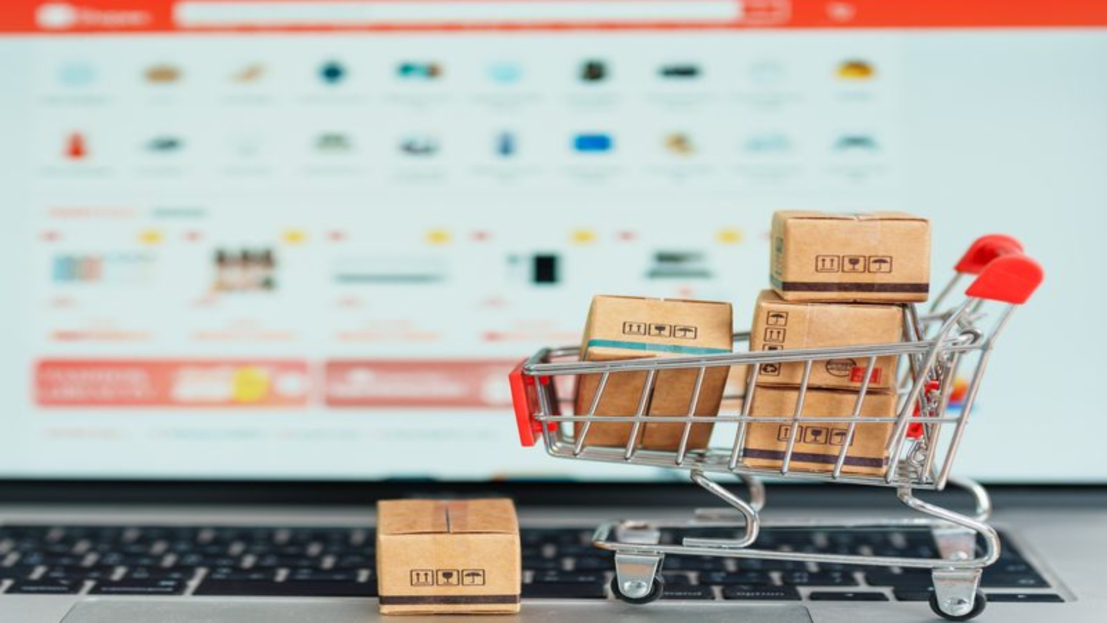 Boxes with shopping cart on a laptop computer. online shopping, Marketplace platform website, technology, ecommerce, shipping delivery, logistics and online payment concepts